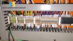 Pick and place product feeder for flowpack transfer cartoning machine