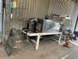 Automatic baling machine with shrink tunnel for bottles and jars in bales.