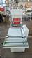 L-shaped packaging sealer with semi-automatic shrink tunnel.