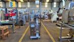 Dosing and packaging machine for granular and powdered products