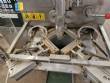 Vertical wrapping machine for triangular format