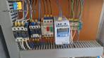 Labeling machine with steam sleeve tunnel and bottle baler