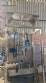 Labeling machine with steam sleeve tunnel and bottle baler