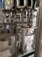 Zegla rotary filling machine with rinser and three-block capping system.